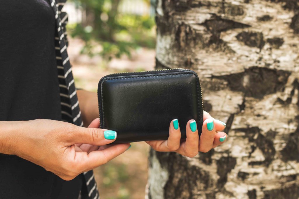 Woman's hands holding a wallet