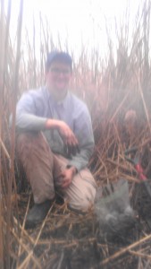A very blurry field shot of Chris Haight getting muddy in the marsh