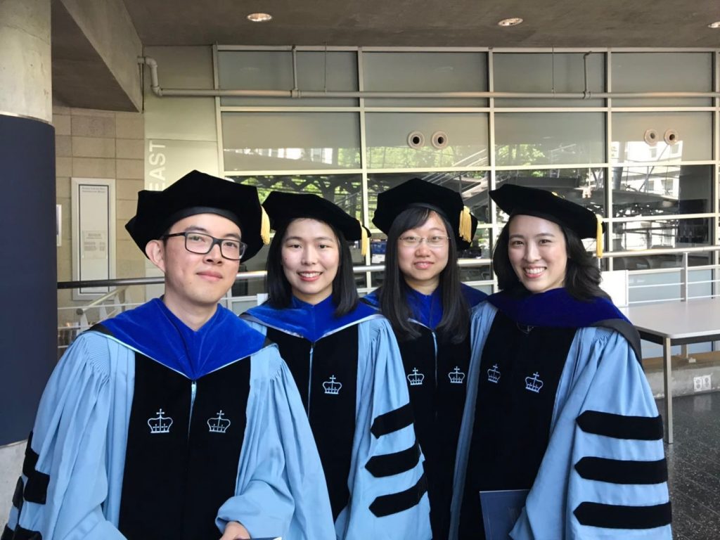 Four graduates in doctoral regalia